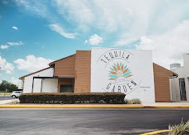 Exterior view of Tequila Garden building under blue sky.