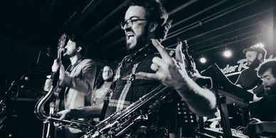 Members of Strange Changes Rocking Out, Saxophonist Colin Edgar in the foreground.