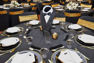 Tuxedo centerpiece and black and gold place settings