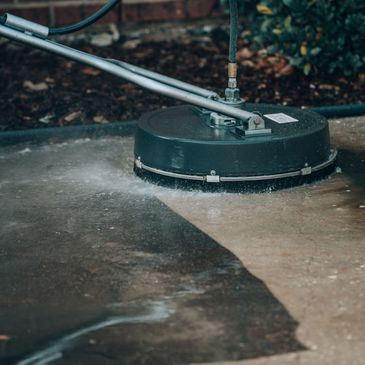 Professionally Pressure washing a patio using a flat surface cleaner