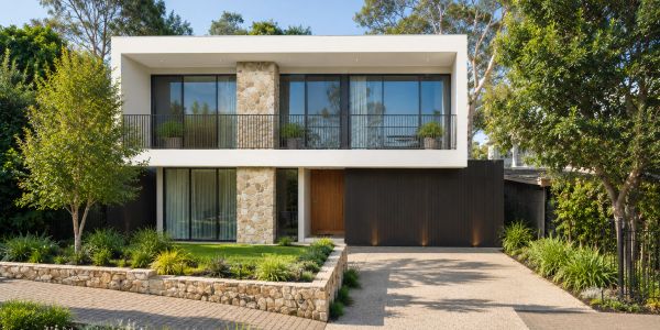 Modern two-story house with stone and glass facade.