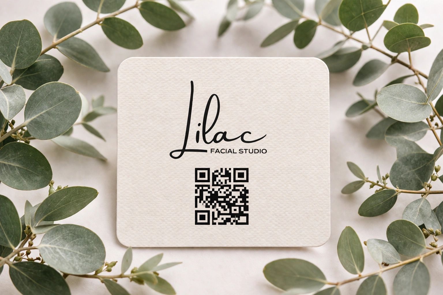 Gift card for Lilac Facial Studio in Sharon, MA styled with eucalyptus in a spa setting. 