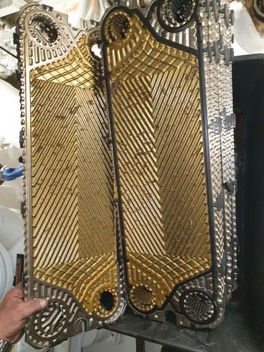 Intricately designed gold and black mechanical component.