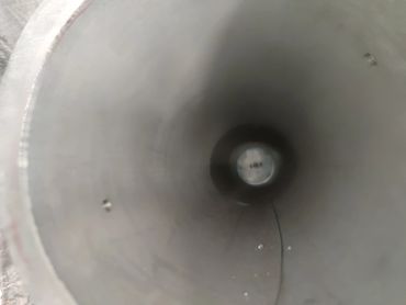 View inside a long, hollow cylindrical pipe.