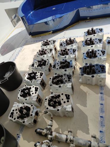Multiple engine cylinder heads arranged on a surface.