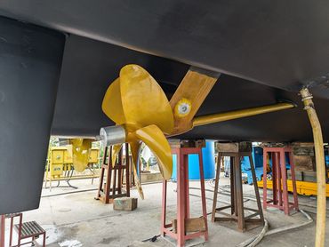 Close-up of a boat propeller on dry dock.