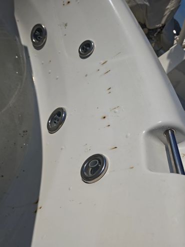 Jets inside a white bathtub with rust marks.