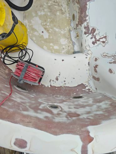 Bathtub surface being stripped and sanded for refinishing.