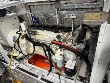 View of a large industrial engine inside a machinery compartment.