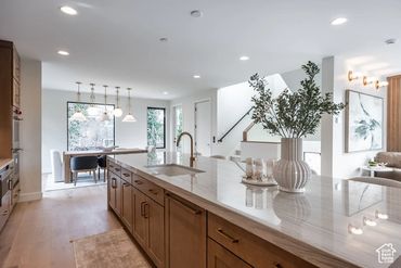 Modern kitchen with a large island and elegant decor.