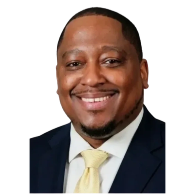 Smiling man in a suit and yellow tie.