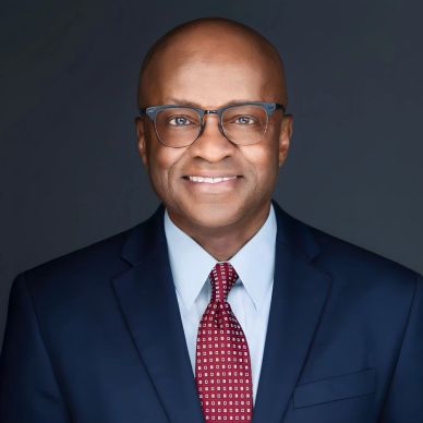 Professional man smiling in suit and tie.