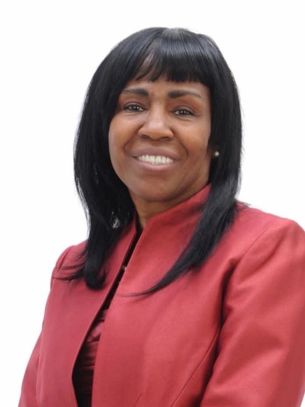 Smiling woman in a red blazer.