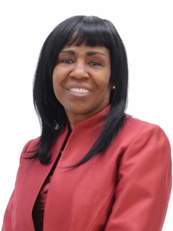 Smiling woman in a red blazer.