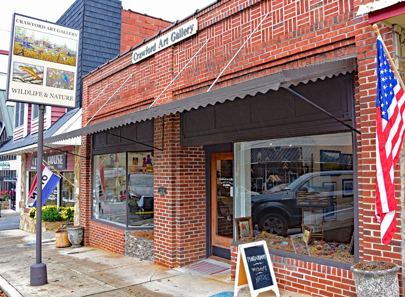 Image of the front of the brick and mortar store for Crawford Art Gallery, 108 N Main Street, Clayto