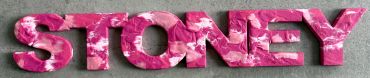 The name Stoney painted in several shades of pink with pink glitter