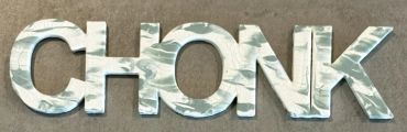 The name Chonk painted in matte sage and white