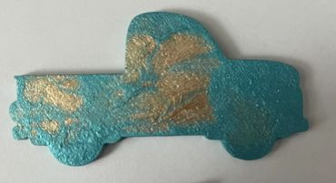 Old truck painted metallic teal and gold