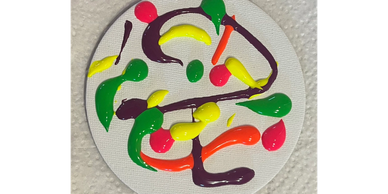 Colorful abstract paint design on round canvas.