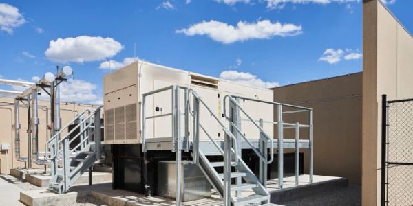 Industrial rooftop equipment under blue sky.