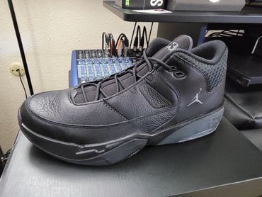 Black Air Jordan basketball shoe with a silver Jumpman logo.