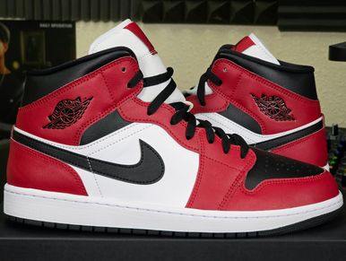 Red, white, and black Air Jordan 1 sneakers displayed side by side.