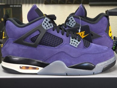 Purple and black Nike Air Jordan sneakers with yellow accents.