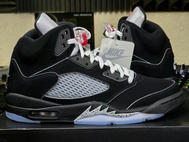 Black and gray Nike Air Jordan 5 sneakers with white laces and translucent soles.