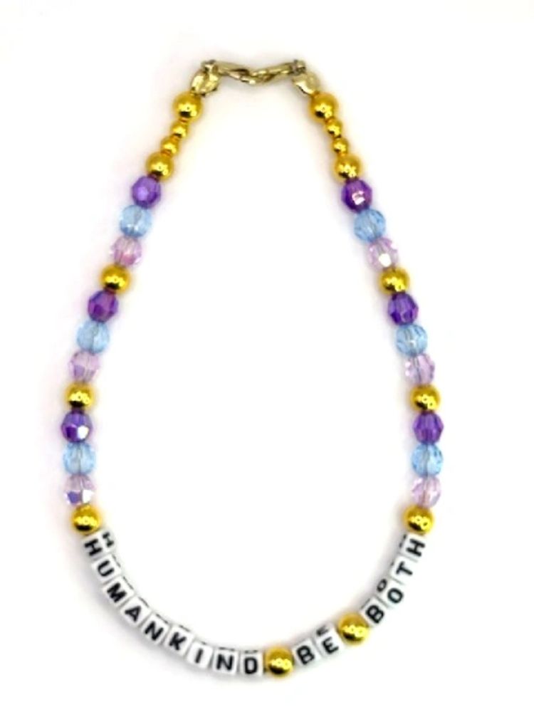 Colorful beaded bracelet with the phrase 'HUMANKIND BE BOTH'.