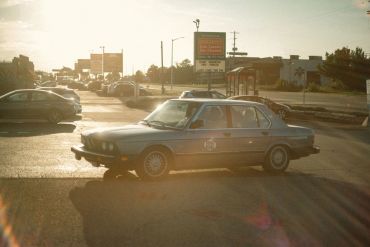 Police car waiting at a traffic light in the evening.