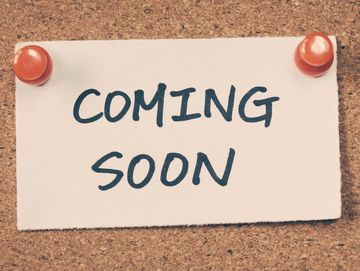 A note pinned to a cork board, the note reads "Coming Soon"