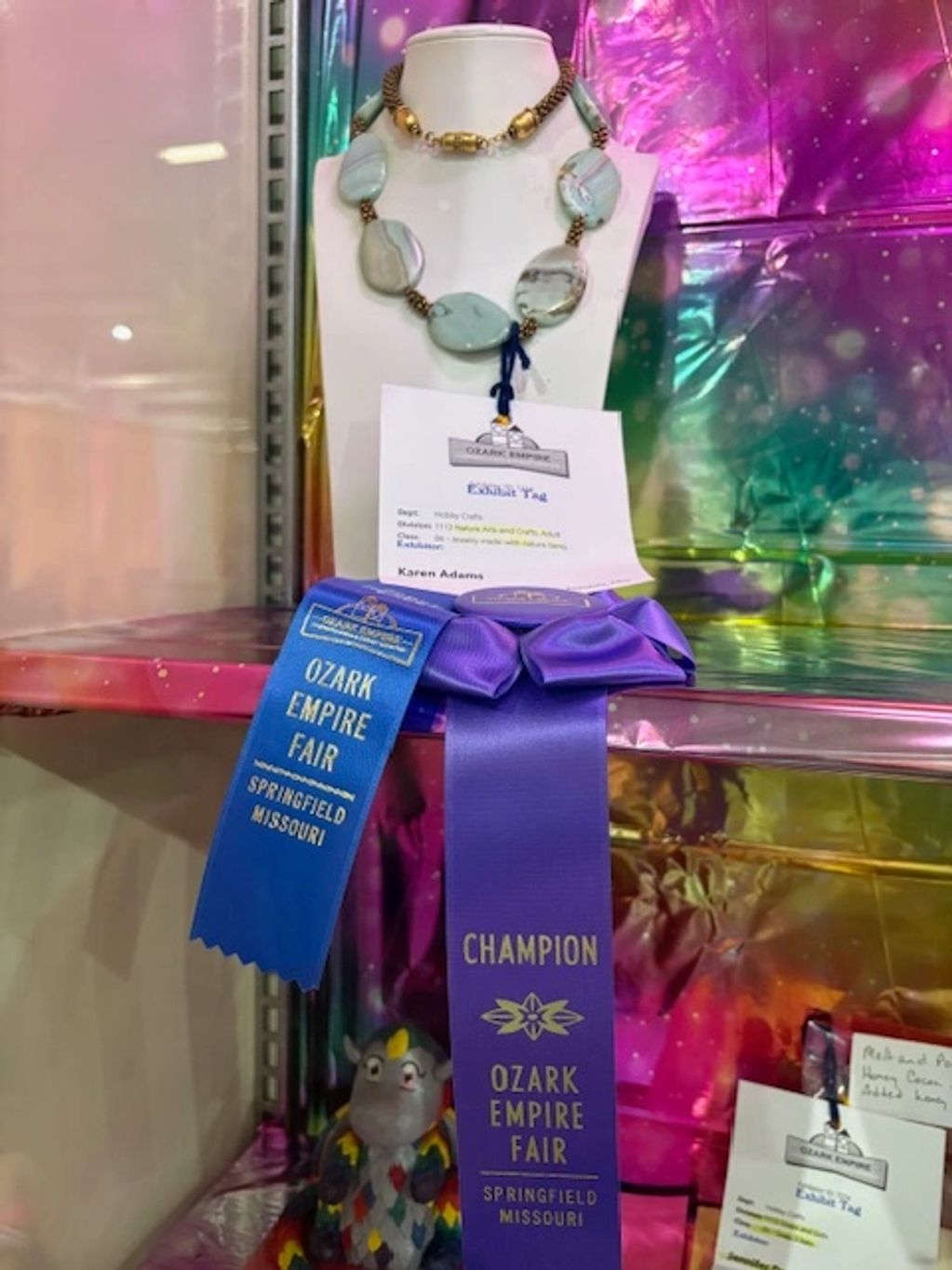 Necklace created with beaded kumihimo by Karen Adams with first place and  champion ribbons