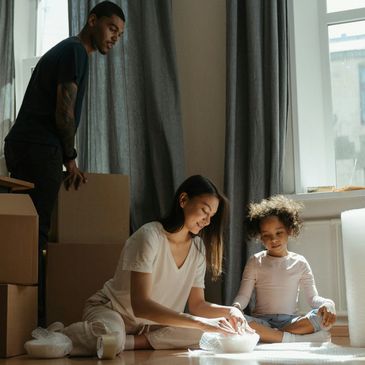 Family moving in or out of a clean house with moving boxes 