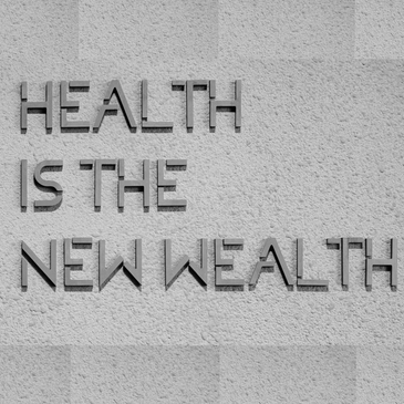 Text on a wall reads 'Health is the new wealth'.