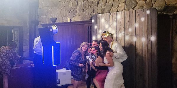 Couple posing with props at wedding photo booth in San Diego