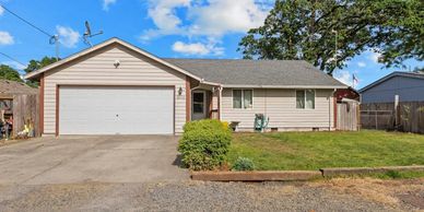 Single-story house with attached garage and a small front lawn.