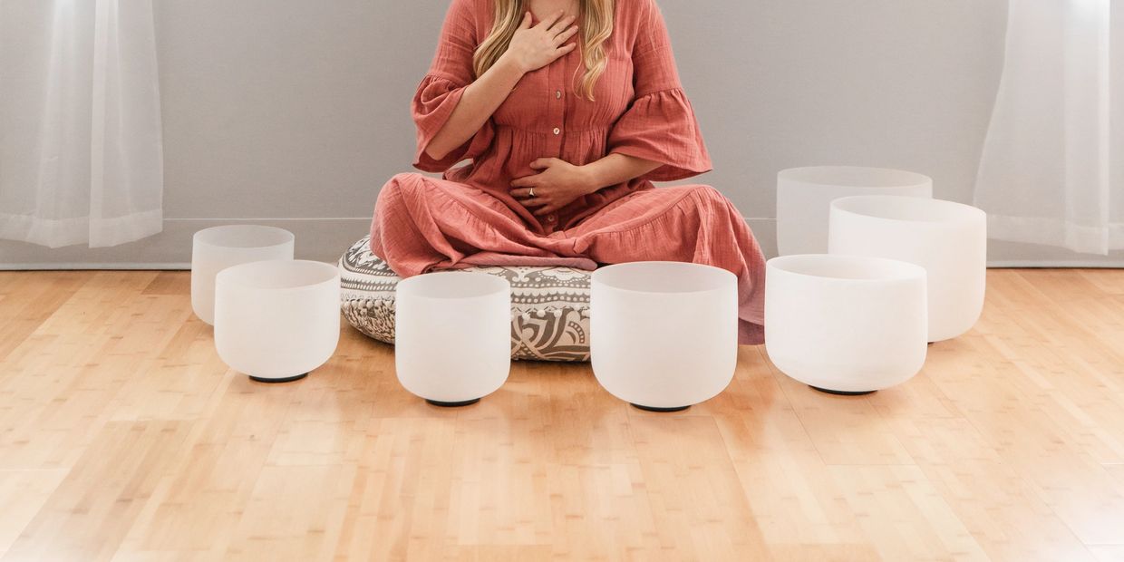 Woman doing breathwork during sound bath meditation in yoga studio
