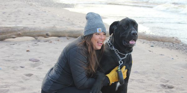 Person and dog on beach of Lake Superior