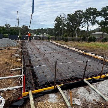 Concrete foundation being prepared at a construction site.