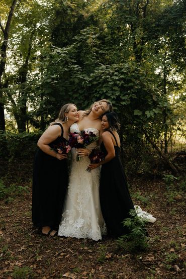 Bride and bridesmaids smiling and hugging