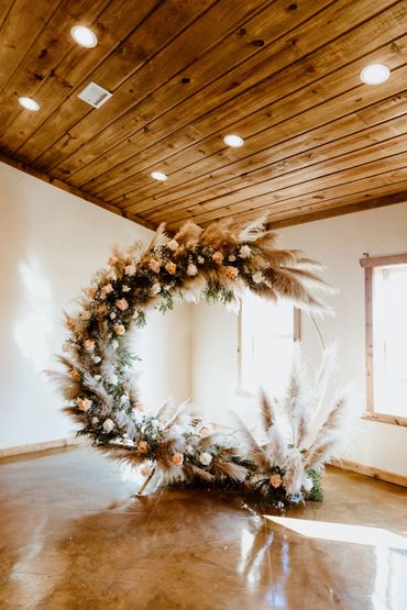 Wedding Ceremony flower circle arch in an empty room