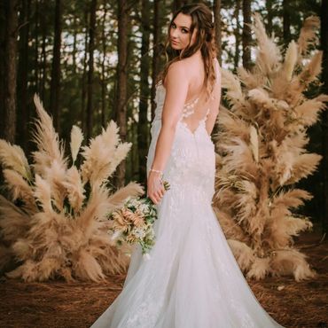 Bride standing in front of pampas flowers