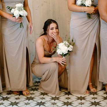 Bridesmaids crying and crouching on floor