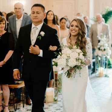 Bride being walked down the aisle at a wedding