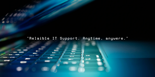 Close-up of a glowing laptop keyboard with IT support text overlay.