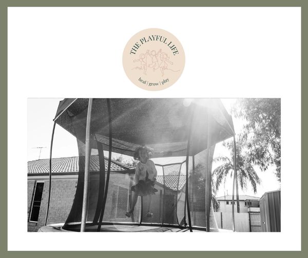 Young child playing on a trampoline outside in the sun.