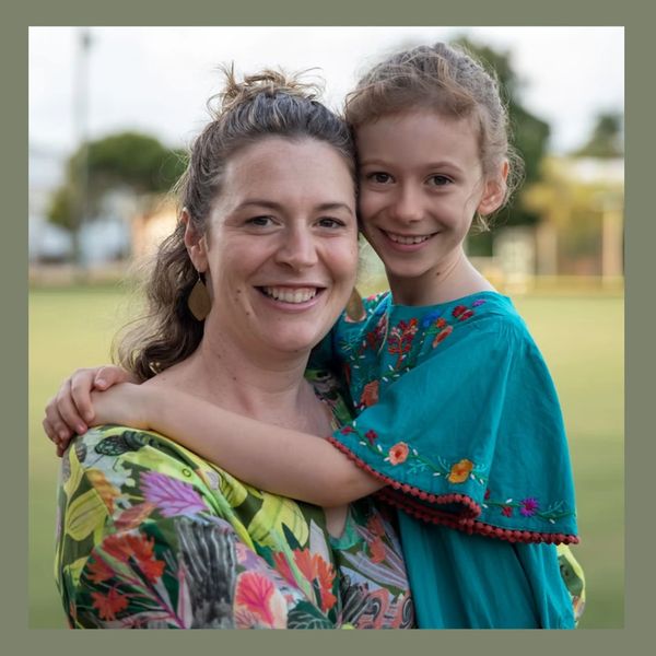 Erin, play therapist and director of The Playful Life holding her daughter.