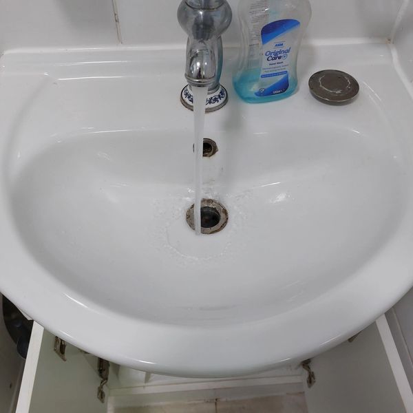 A bathroom sink cleared of scale blockage in Hertford
