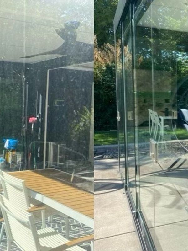 Glass patio with outdoor furniture and ladder.