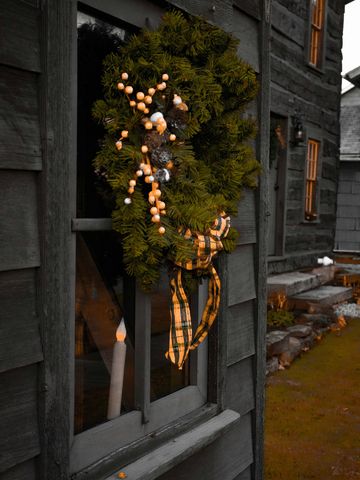Christmas or winter holiday themed porch decor styled for you. Greenery, garland, wreathes, and more.